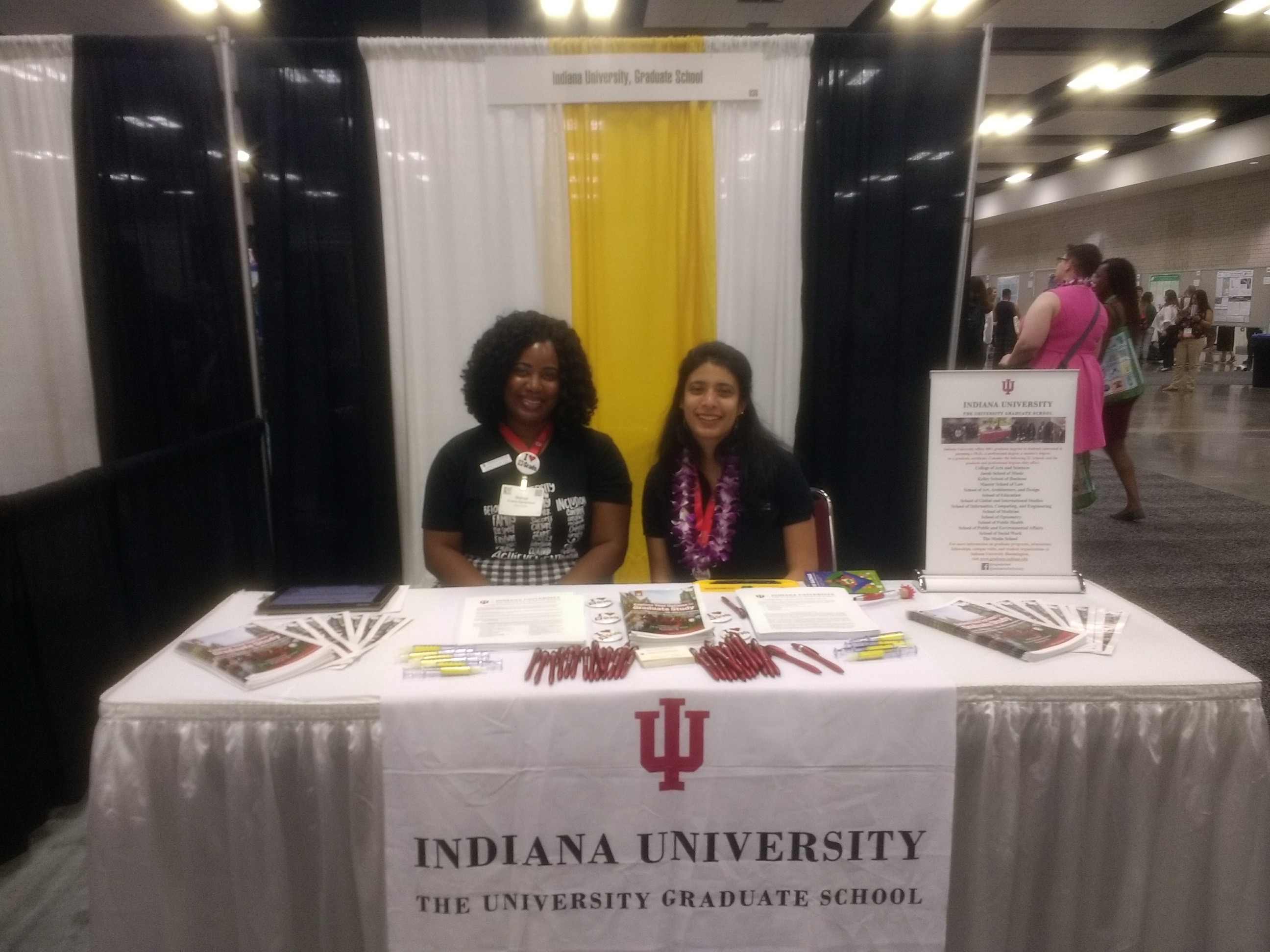 Two ladies at an Indiana University Graduate School fair booth